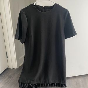 Black dress with poms at the bottom